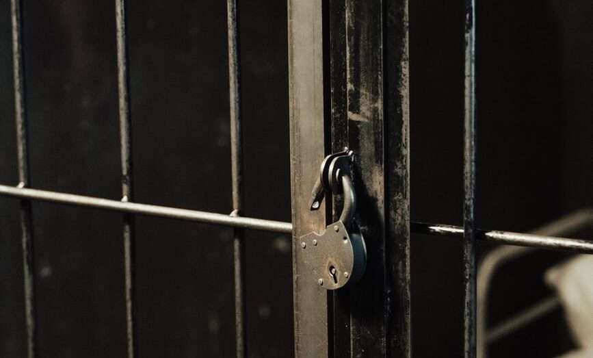 jail bars closed with padlock
